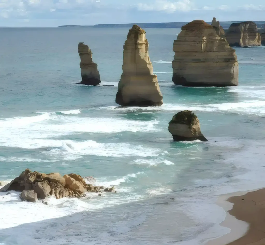 The massive offshore rock stacks of the 12 Apostles, an iconic attraction on the Great Ocean Road. In the foreground is the rubble of a collapsed stack.